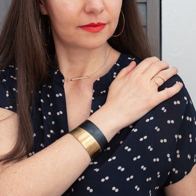 model wearing bracelets, ring, earrings, and a necklace
