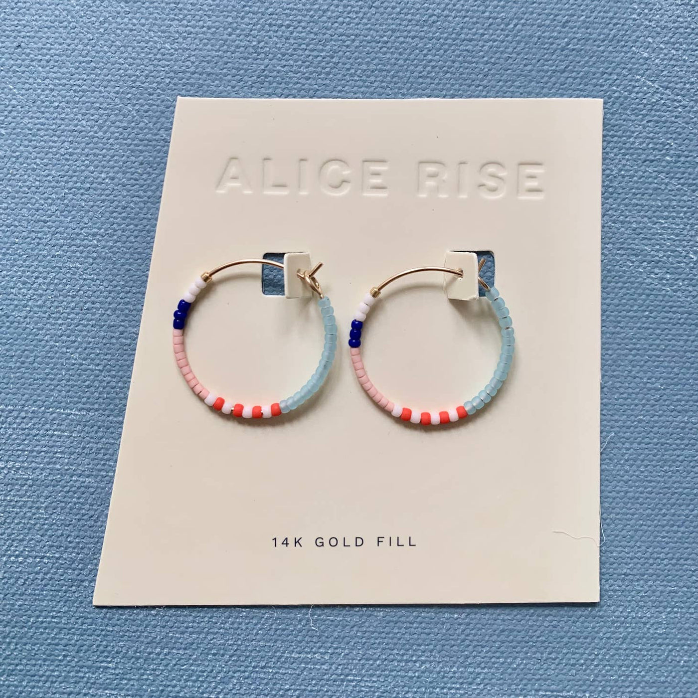 little color loop hoop earrings by alice rise on a card
