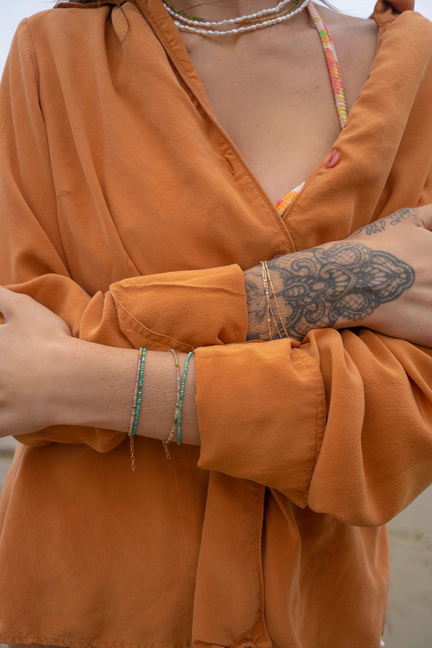 May Martin's minimalist bracelets on a model's arm