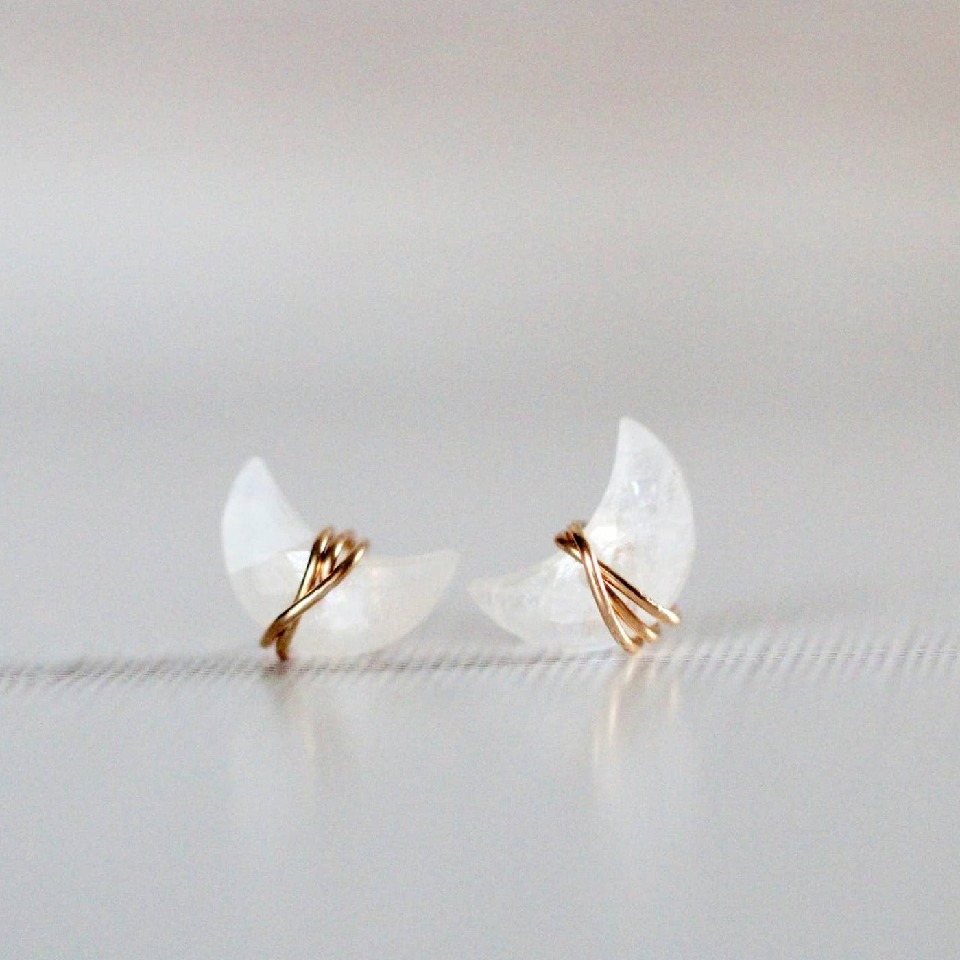 earring studs with moonstone gemstones in a moon shape wrapped in 14k gold fill earring wire