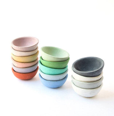 3 stacks of tiny round ring dishes in different colors