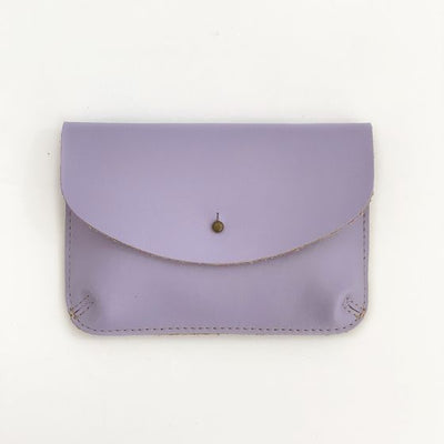 Front of a lavender color leather wallet, shaped like an envelope with a metal snap enclosure
