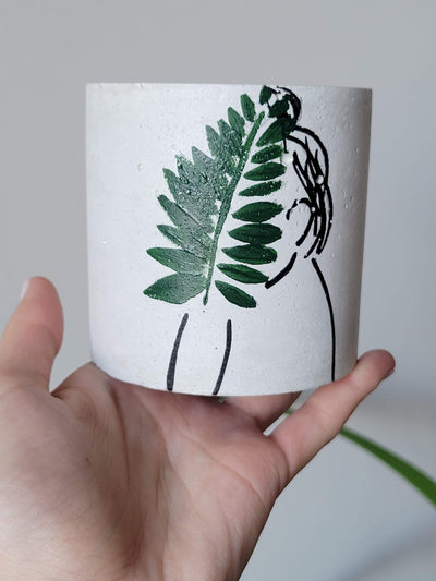 concrete planter with hand drawn girl outline