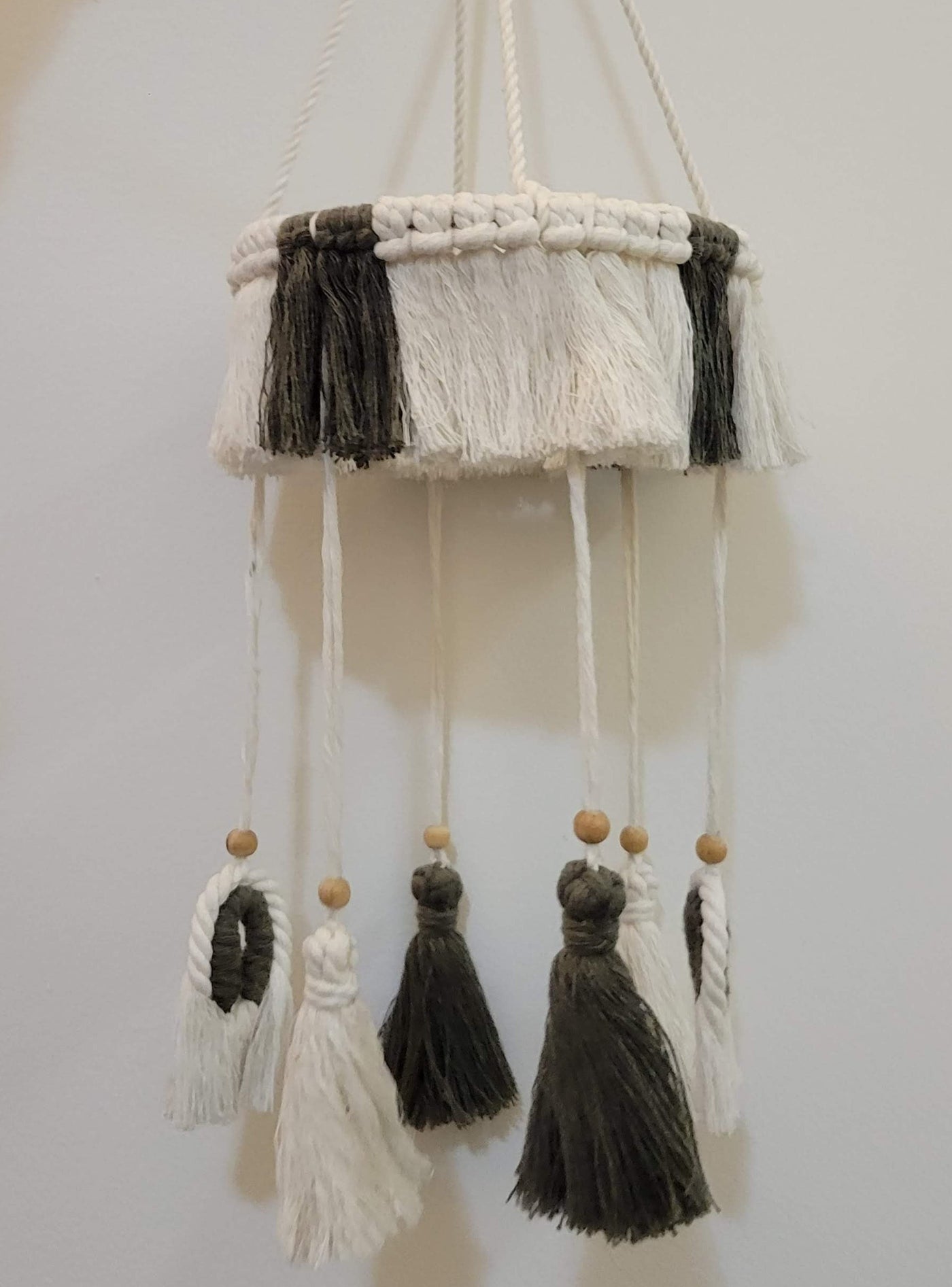 gray and white macrame mobile for crib