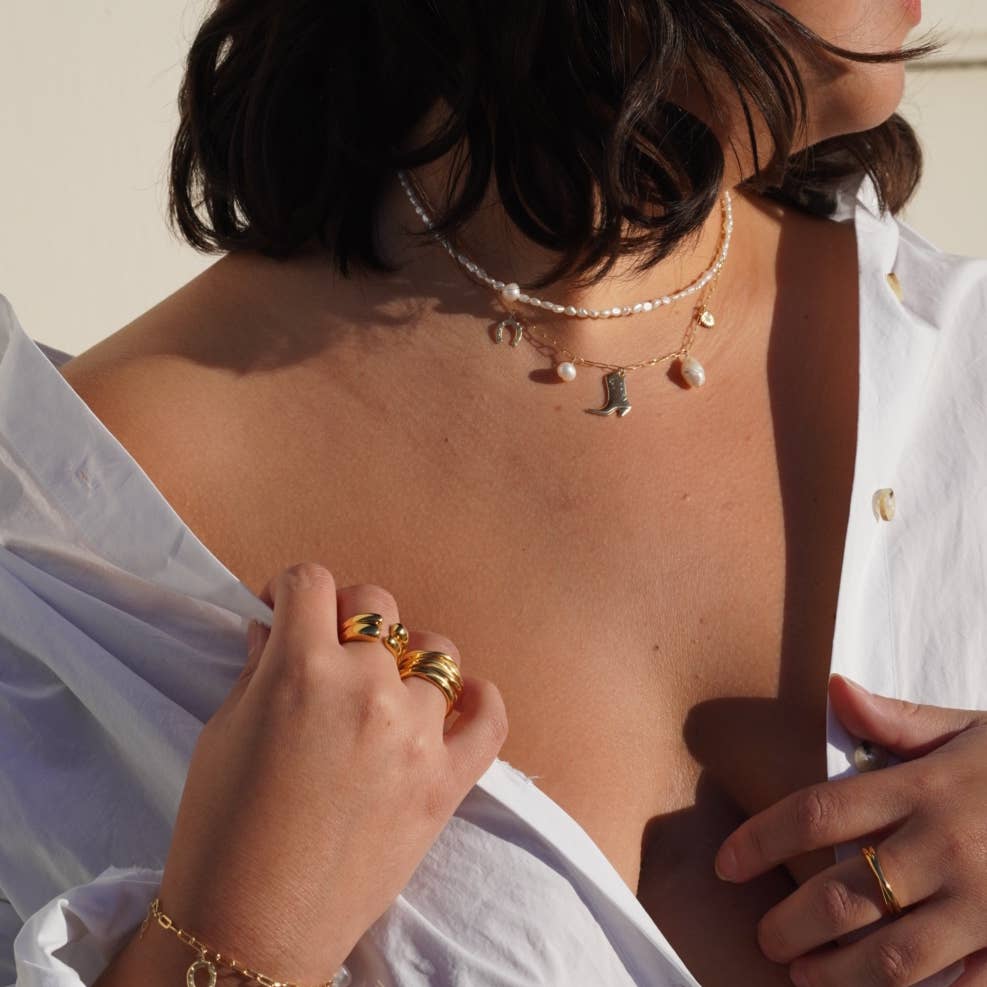 model wearing choker necklace with fresh water pearls and an African opal bead