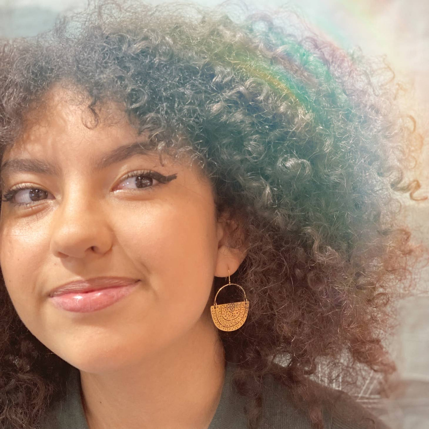 inverted rainbow earrings on a model