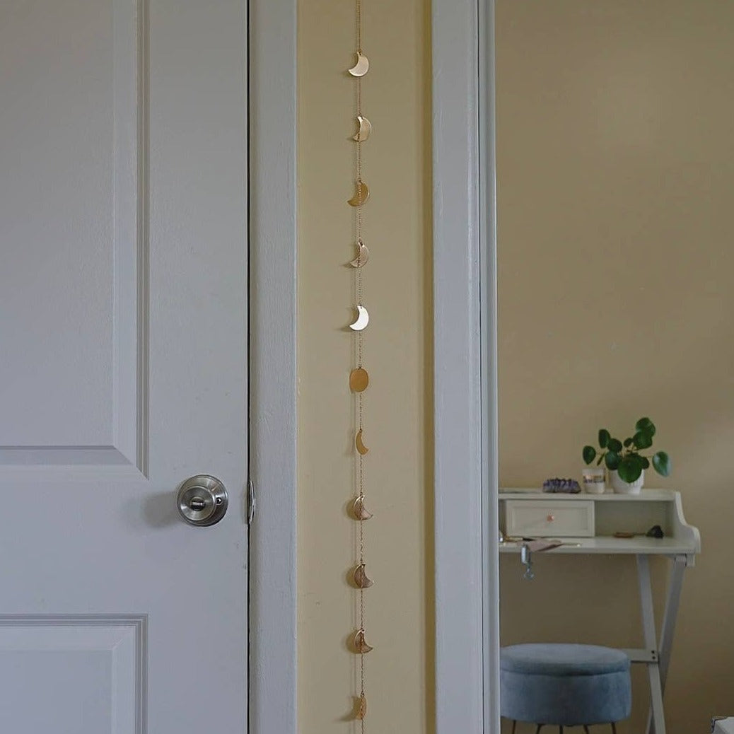 vertical hanging wall garland with hand-cut moons strung on brass chain