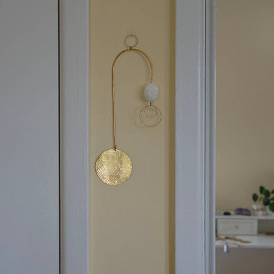 wall hanging with brass disc and selenite stone