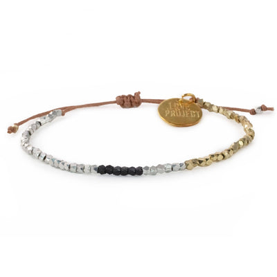 silver, gold and black beaded bracelet with brown adjustable string and gold charm that reads love is project
