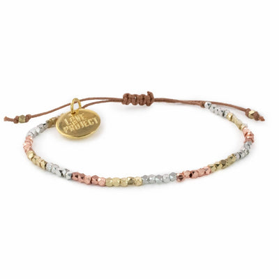 silver, gold and rose gold beaded bracelet with brown adjustable string and gold charm that reads love is project