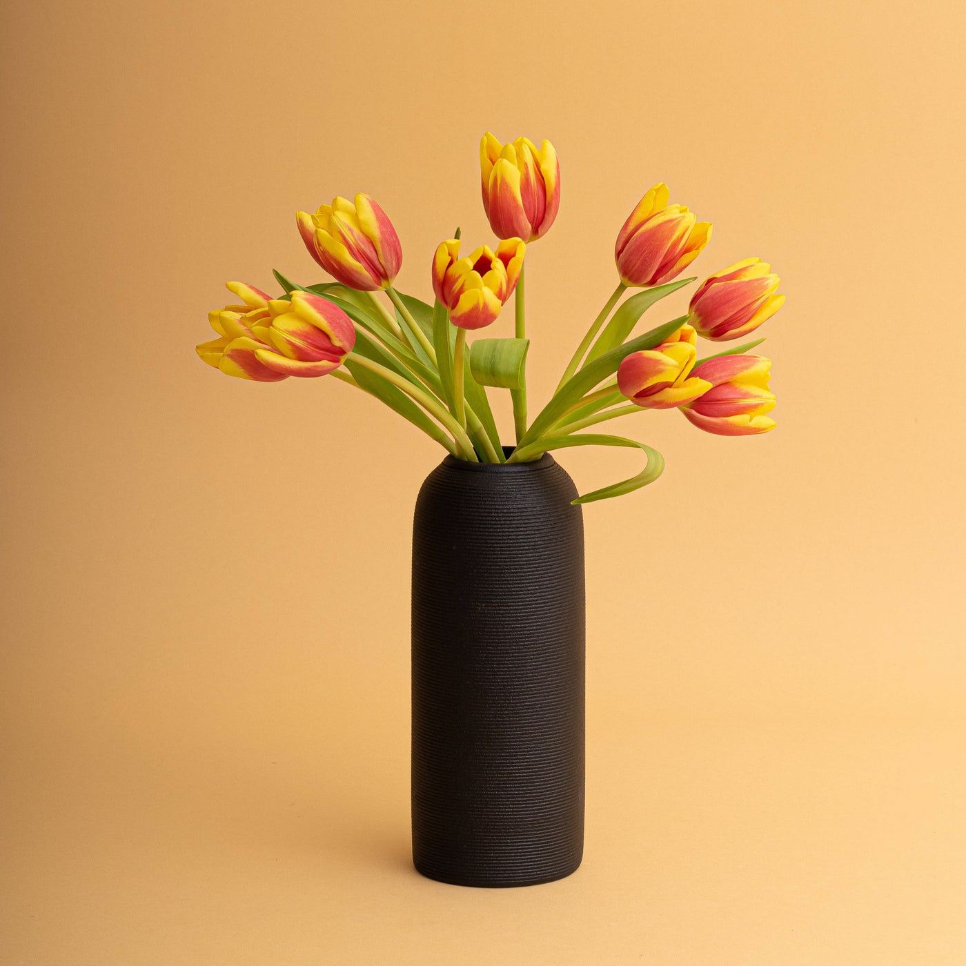 black pillar vase with tulips