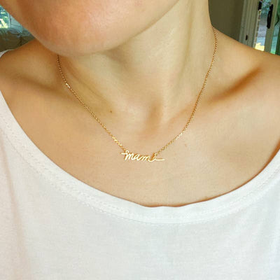 gold plated mama necklace on model