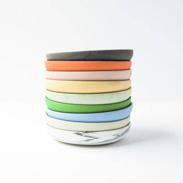 Stack of round trinket trays in different colors