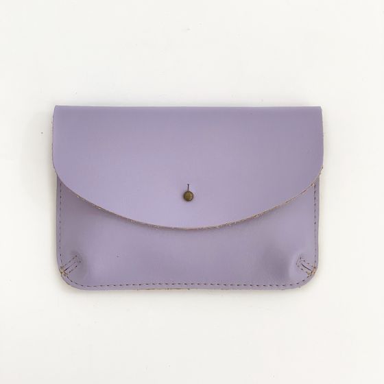 Front of a lavender color leather wallet, shaped like an envelope with a metal snap enclosure