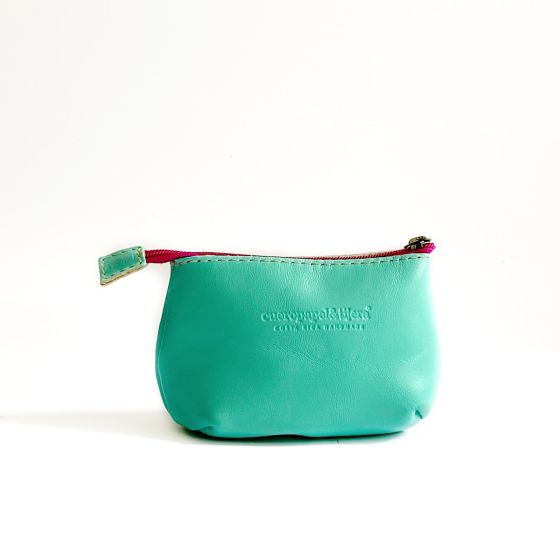 Leather coin pouch in aqua with a hot pink zipper; logo of maker pressed into leather in front center